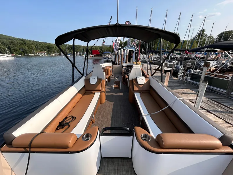 Slide: The Image of 2024 Avalon Catalina Quad Lounge 25' pontoon boat docked at a marina. - 10
