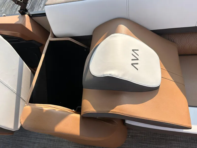 Slide: The Image of 2024 Avalon Catalina Quad Lounge seat with storage compartment, featuring tan and white upholstery. - 18