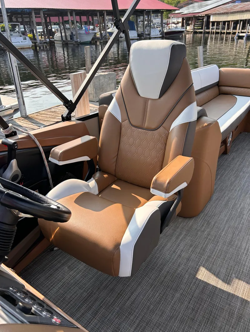 Slide: The Image of 2024 Avalon Catalina Quad Lounge boat seat, luxurious design, docked by the water. - 24