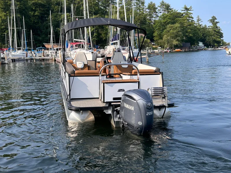 Slide: The Image of 2024 Avalon Catalina Quad Lounge 25' pontoon boat with Yamaha engine on a scenic lake. - 6