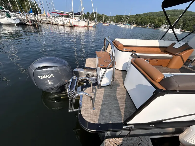 Slide: The Image of 2024 Avalon Catalina Quad Lounge 25' pontoon boat docked with Yamaha motor. - 7