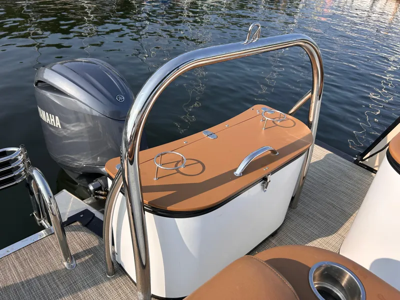 Slide: The Image of 2024 Avalon Catalina Quad Lounge boat with Yamaha motor on calm water. - 8