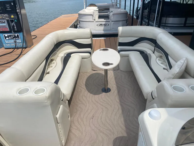 Slide: The Image of 2007 Aloha Pontoon PS 220 TT with spacious seating and table on a docked boat. - 10