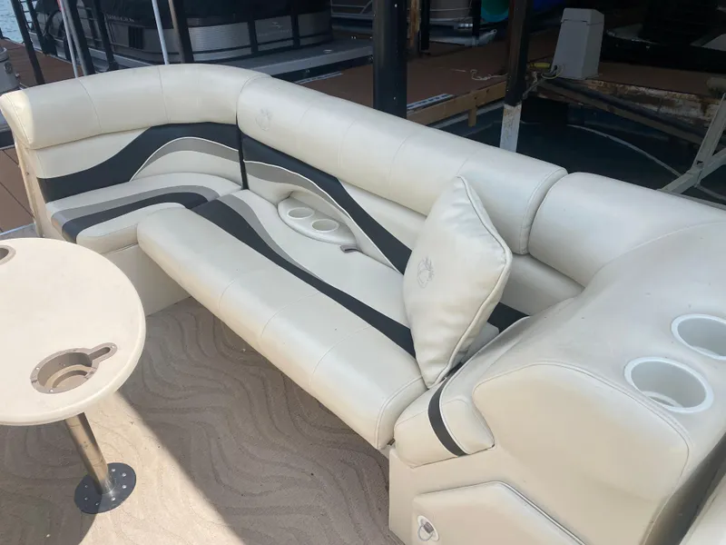 Slide: The Image of 2007 Aloha Pontoon PS 220 TT interior with beige seating and cup holders. - 11