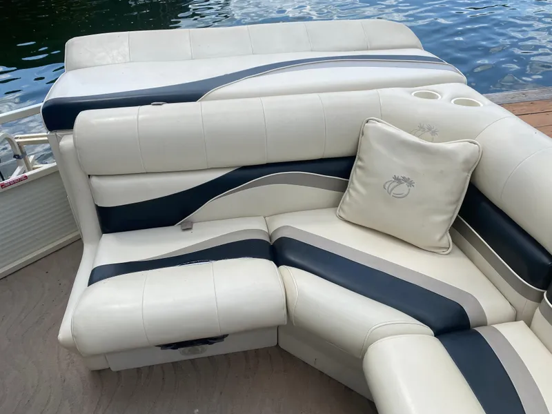 Slide: The Image of 2007 Aloha Pontoon PS 220 TT with white and navy seating by the water. - 12