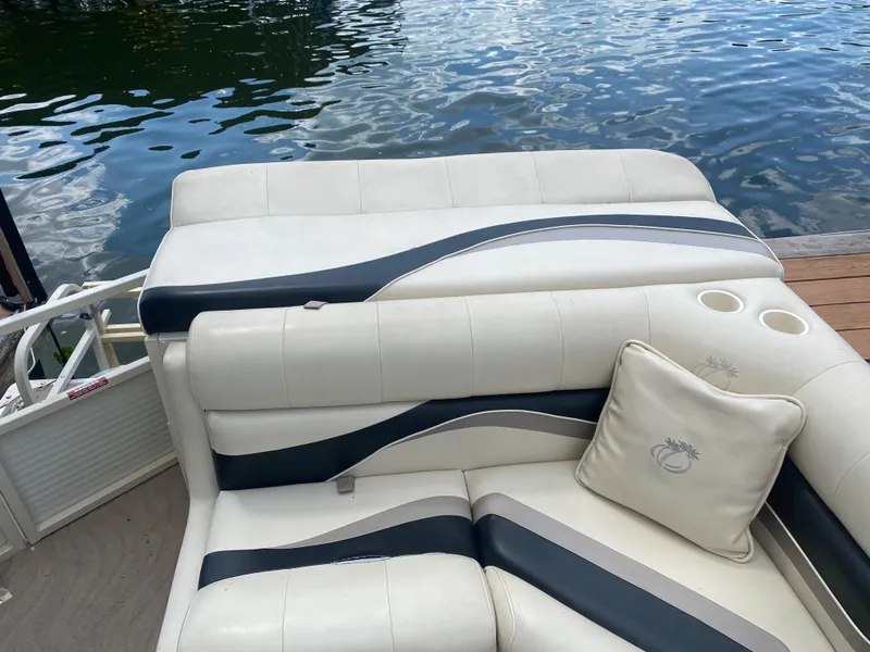 Slide: The Image of 2007 Aloha Pontoon PS 220 TT with white and black seating by the water. - 13