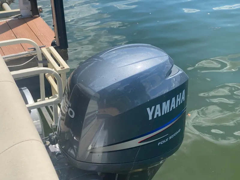 Slide: The Image of Yamaha outboard motor on 2007 Aloha Pontoon PS 220 TT, docked on calm water. - 14