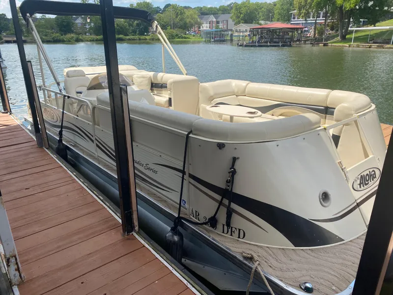 Slide: The Image of 2007 Aloha Pontoon PS 220 TT docked on a serene lake. - 2