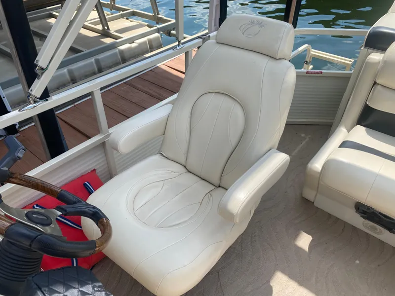 Slide: The Image of 2007 Aloha Pontoon PS 220 TT captain's chair, beige leather, on a boat deck. - 9