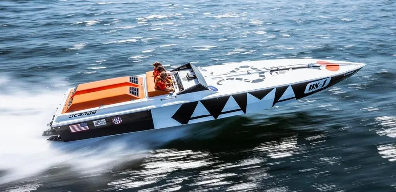 The Image of 1979 Scarab Larry Smith 38 speedboat racing on open water. - 1