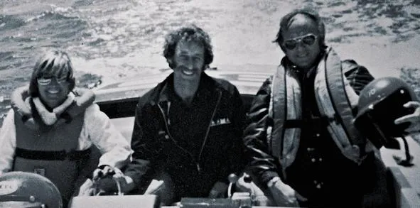 Slide: The Image of Three people on a 1979 Scarab Larry Smith 38 boat, wearing life jackets. - 6