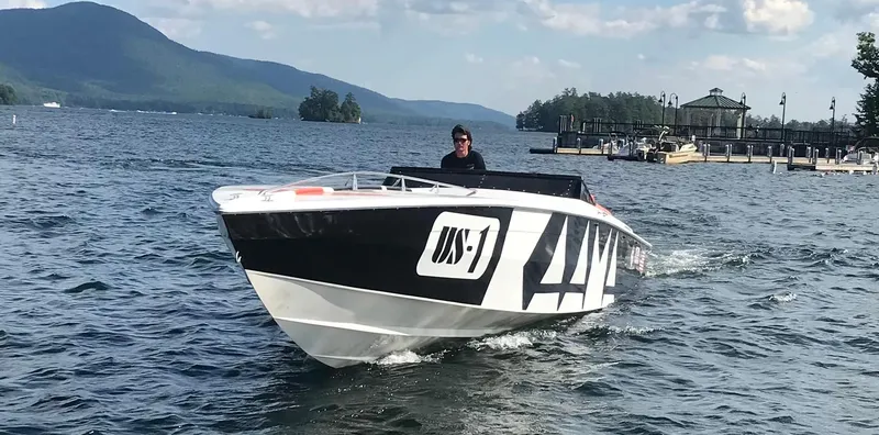 Slide: The Image of 1979 Scarab Larry Smith 38 speedboat cruising on a scenic lake. - 9