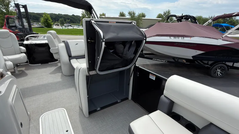 Slide: The Image of The image shows the interior of a 2025 Starcraft EXS 3 FD TT boat with seating and storage. - 24