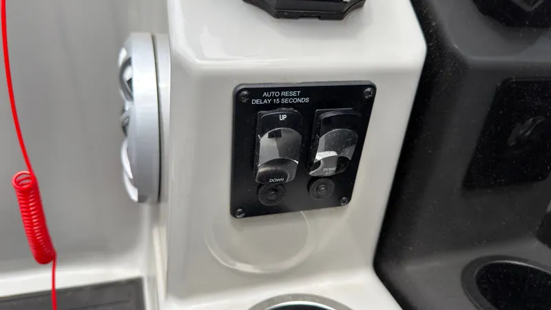 Slide: The Image of Close-up of control knobs on a boat, with a red cord in the background. - 46