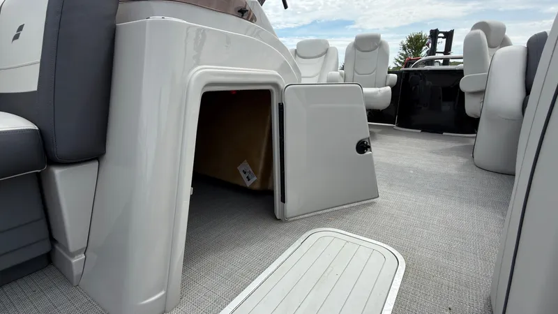 Slide: The Image of The image shows the interior of a 2025 Starcraft EXS 3 FD TT boat with seating and storage. - 28