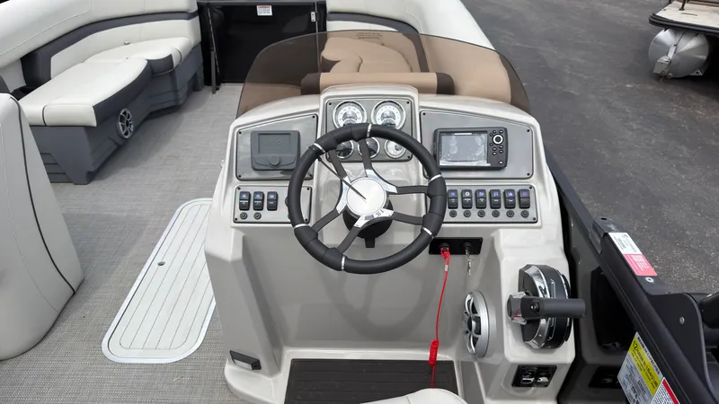 Slide: The Image of 2025 Starcraft EXS 3 FD TT: Helm with steering wheel, gauges, and comfortable seating. - 38