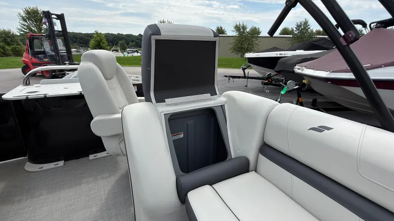 Slide: The Image of The image shows the interior of a 2025 Starcraft EXS 3 FD TT with sleek seating and storage space. - 35