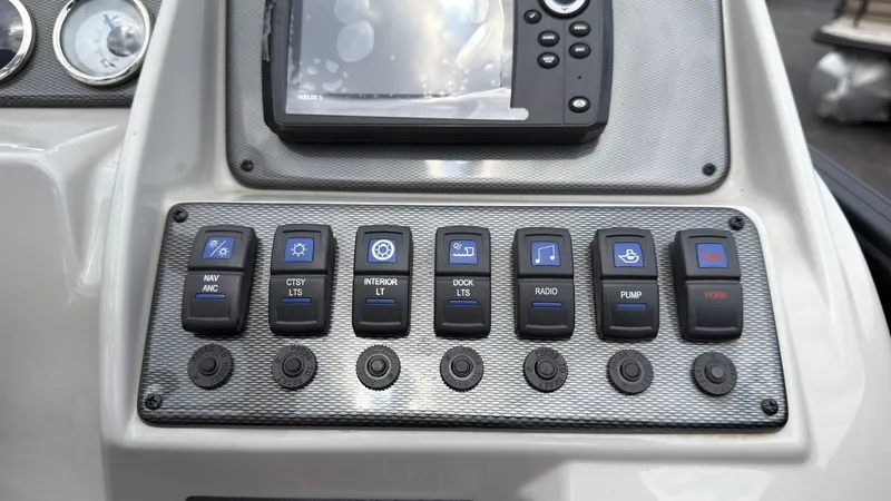 Slide: The Image of Dashboard of the 2025 Starcraft EXS 3 FD TT with various switches and a display. - 44