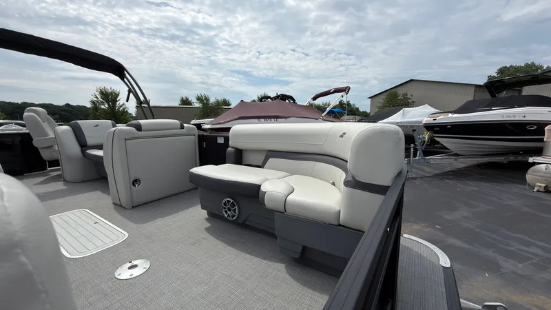 Slide: The Image of The image shows a modern pontoon boat with white seating and gray flooring outdoors. - 10