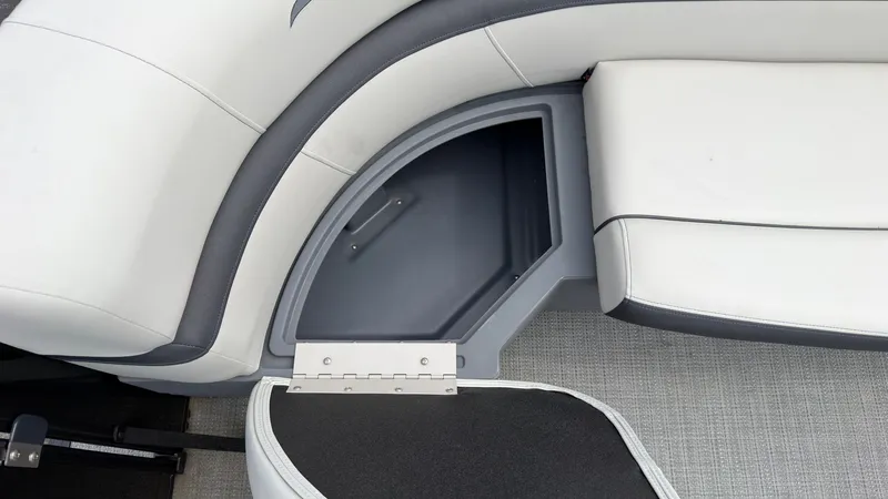 Slide: The Image of A seating area with gray upholstery and an open storage compartment underneath. - 19