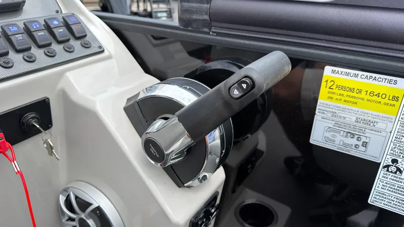 Slide: The Image of Close-up of the throttle and controls on a Starcraft EXS 3 FD TT boat. - 45