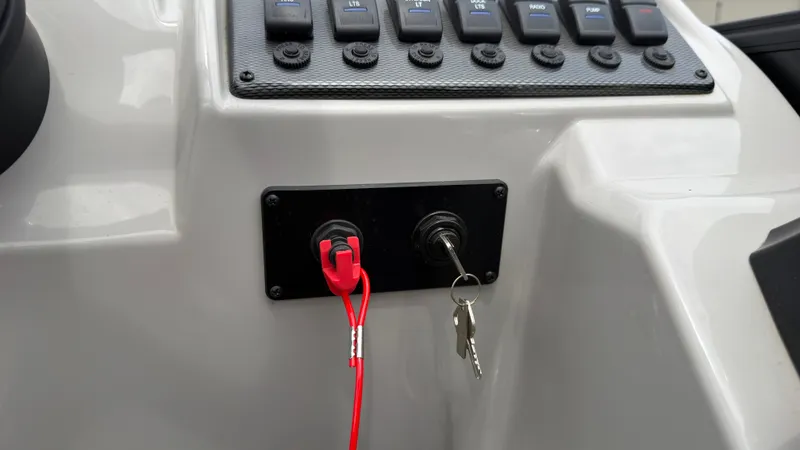 Slide: The Image of Close-up of a boat control panel with key switch and red safety lanyards. - 48