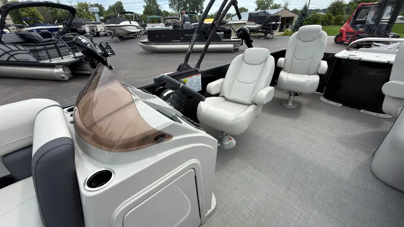 Slide: The Image of The image shows the cockpit of a 2025 Starcraft EXS 3 FD TT with white leather seats. - 36