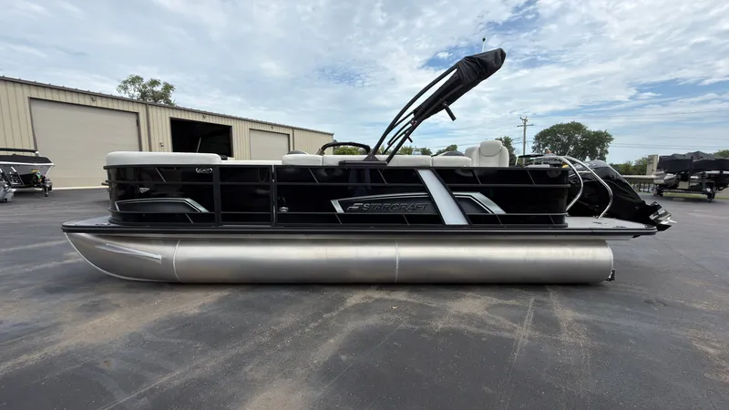 Slide: The Image of The image shows a 2025 Starcraft EXS 3 FD TT pontoon boat parked on a lot. - 5