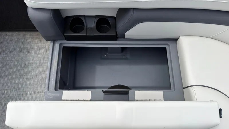 Slide: The Image of The image shows an open storage compartment in a boat with two cup holders. - 16