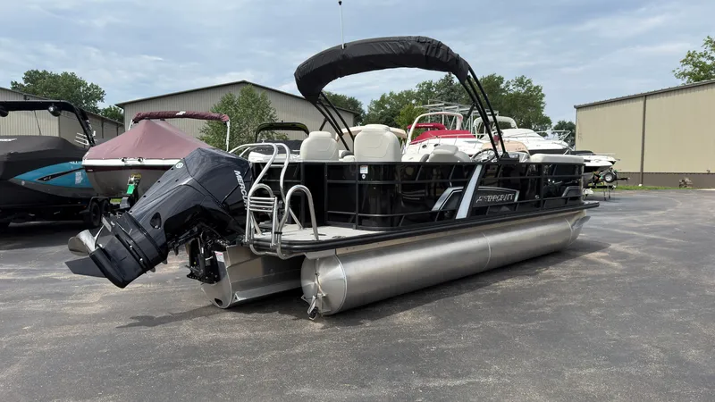 Slide: The Image of 2025 Starcraft EXS 3 FD TT pontoon boat with black bimini top and outboard motor. - 2