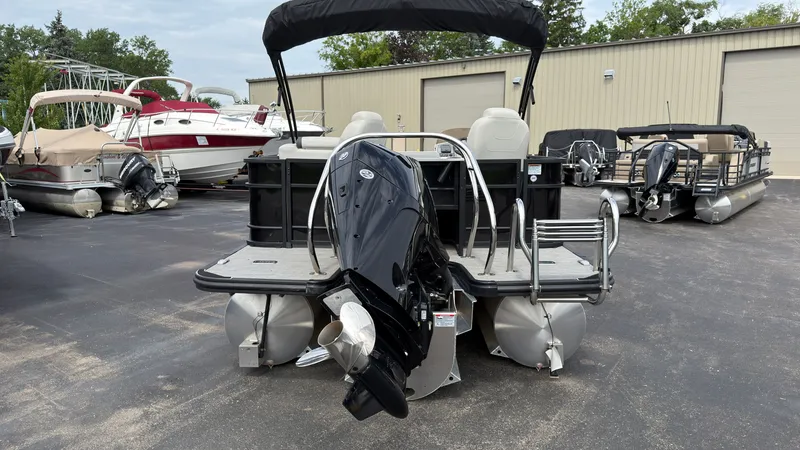 Slide: The Image of The image shows a 2025 Starcraft EXS 3 FD TT pontoon boat with an outboard motor. - 3