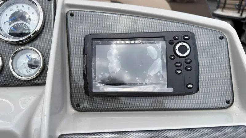 Slide: The Image of The image shows a helm with a Humminbird fish finder and a tachometer. - 43