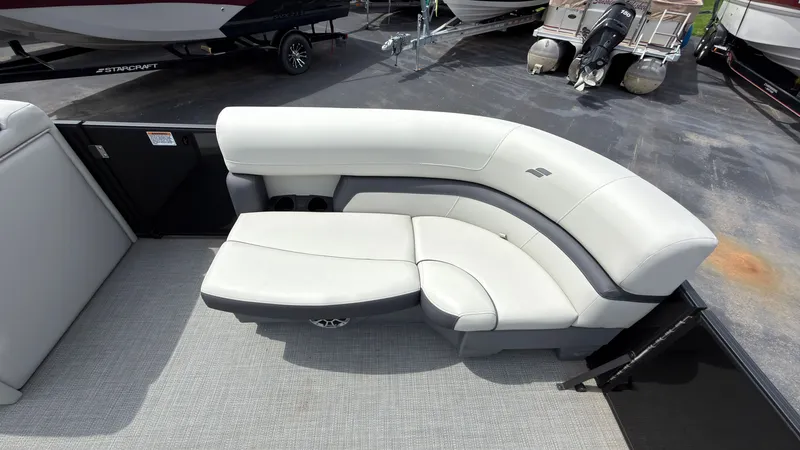 Slide: The Image of The image shows a modern, cushioned seating area on a boat, surrounded by other boats in the background. - 12
