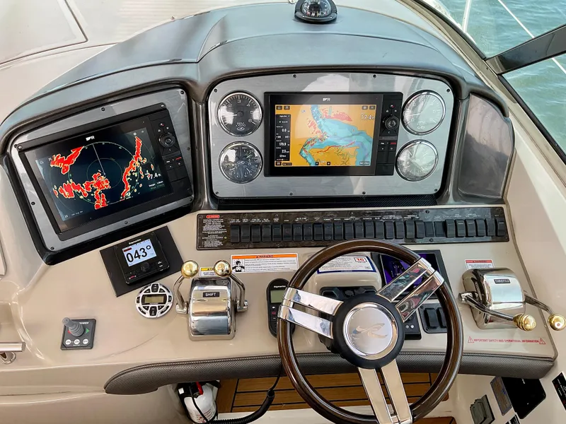 Slide: The Image of 2007 Sea Ray 38 Sundancer helm with navigation screens and controls. - 12