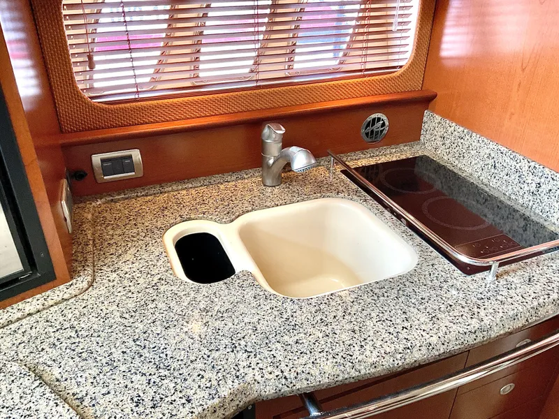 Slide: The Image of Granite countertop with sink and stove in 2007 Sea Ray 38 Sundancer yacht kitchen. - 16