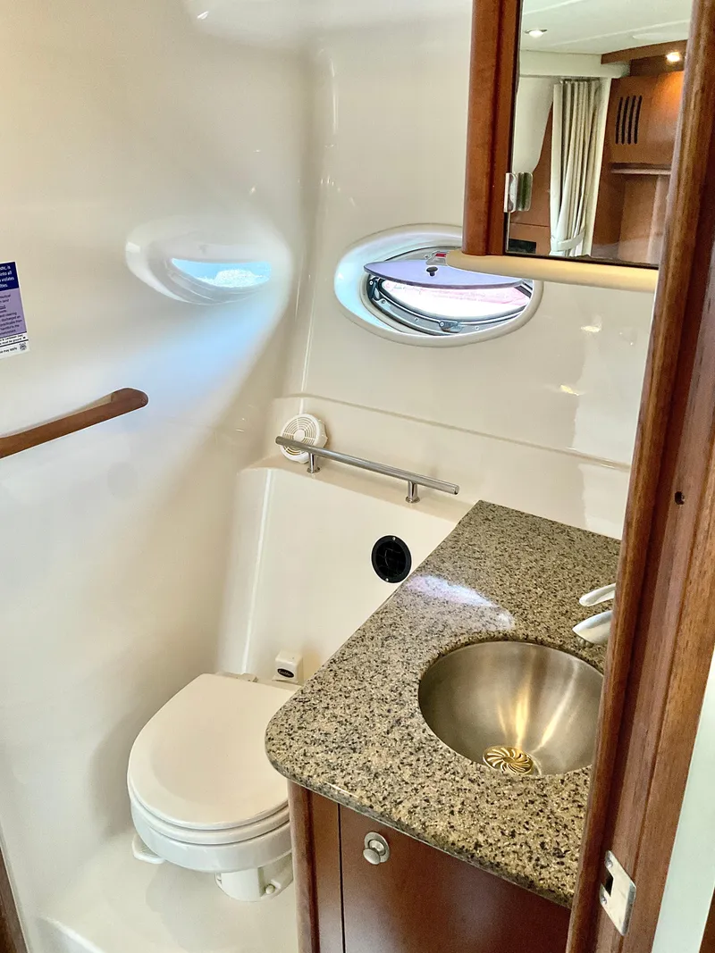 Slide: The Image of Luxurious bathroom in 2007 Sea Ray 38 Sundancer yacht with granite countertop and stainless steel sink. - 20