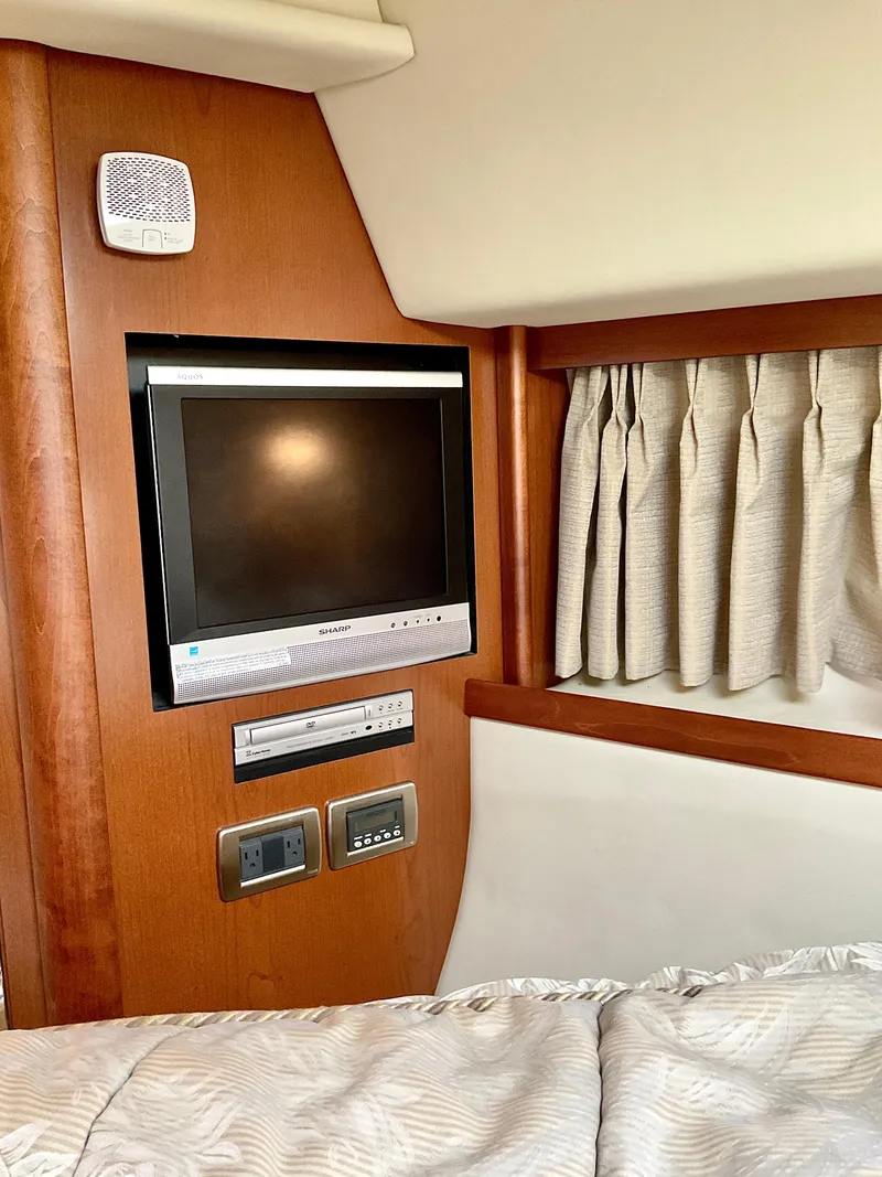 Slide: The Image of 2007 Sea Ray 38 Sundancer cabin interior with TV and control panel. - 21