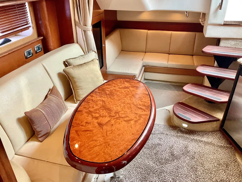 Slide: The Image of Luxurious 2007 Sea Ray 38 Sundancer yacht interior with elegant seating and wooden table. - 23