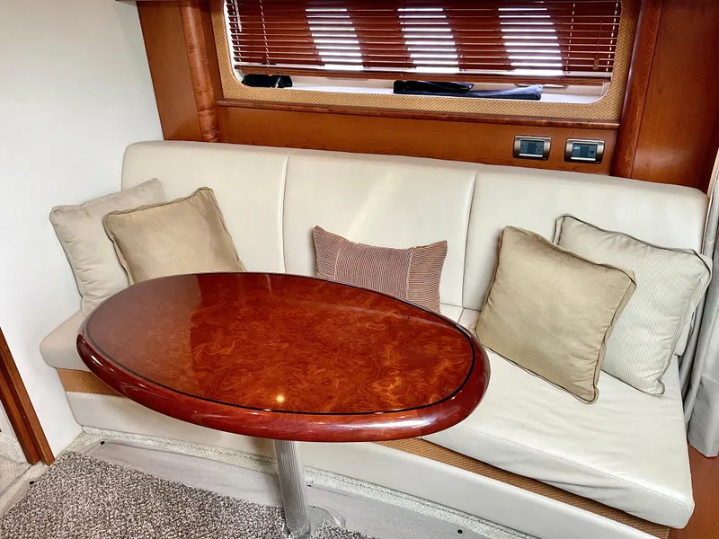 Slide: The Image of Luxurious 2007 Sea Ray 38 Sundancer interior with elegant seating and wooden table. - 24