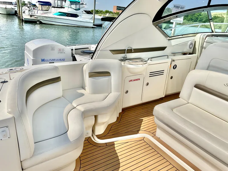 Slide: The Image of 2007 Sea Ray 38 Sundancer yacht interior with white seating and wood flooring. - 4