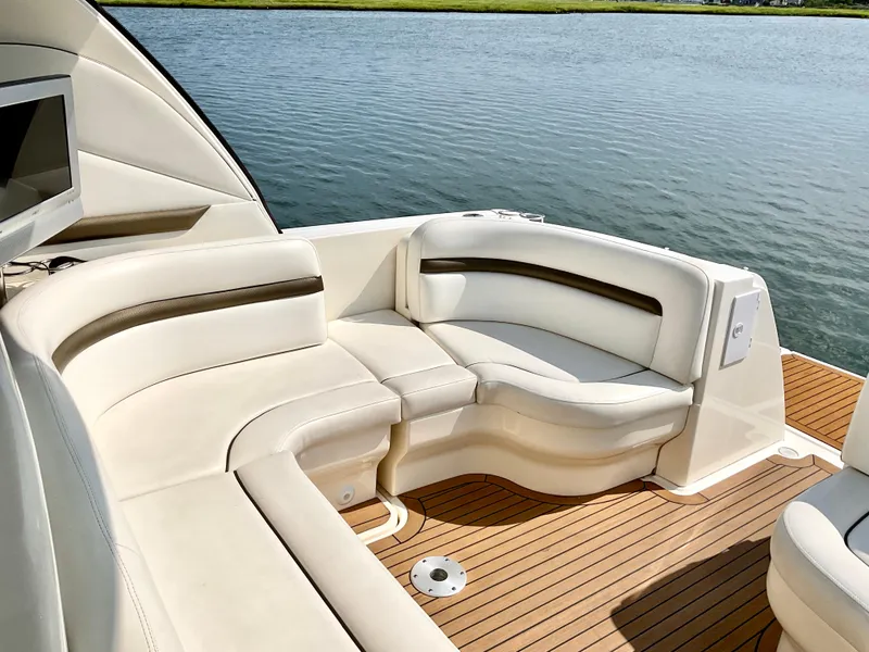 Slide: The Image of Luxurious seating on 2007 Sea Ray 38 Sundancer yacht, overlooking serene water. - 5
