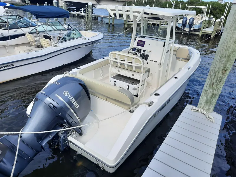 Slide: The Image of 2020 Century 2301 Center Console boat docked with Yamaha outboard engine. - 17