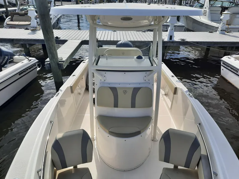 Slide: The Image of 2020 Century 2301 Center Console boat docked at marina, featuring spacious seating and helm. - 19