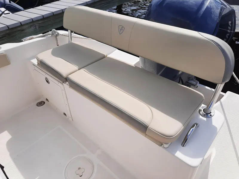 Slide: The Image of Century 2301 Center Console 2020 boat with beige seating and storage compartment. - 22