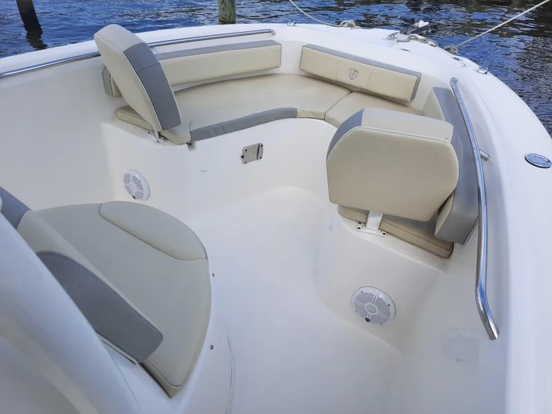 Slide: The Image of Century 2301 Center Console 2020 boat interior with cushioned seating and speakers. - 23