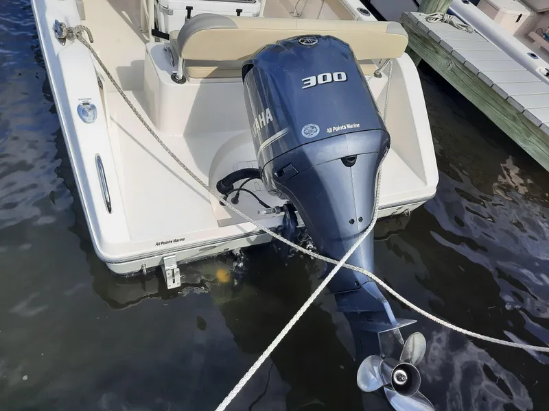 Slide: The Image of Century 2301 Center Console 2020 with Yamaha 300 outboard motor docked in water. - 32