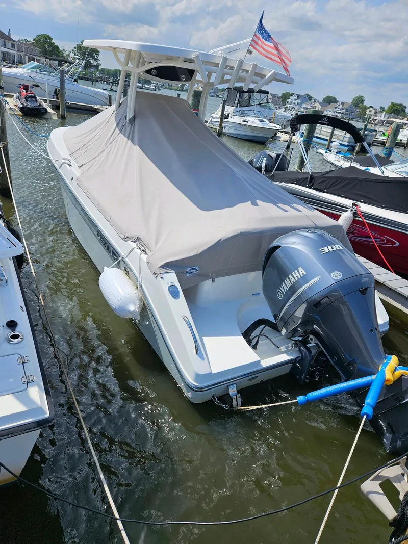 Slide: The Image of Century 2301 Center Console 2020 boat docked with cover and Yamaha engine. - 33