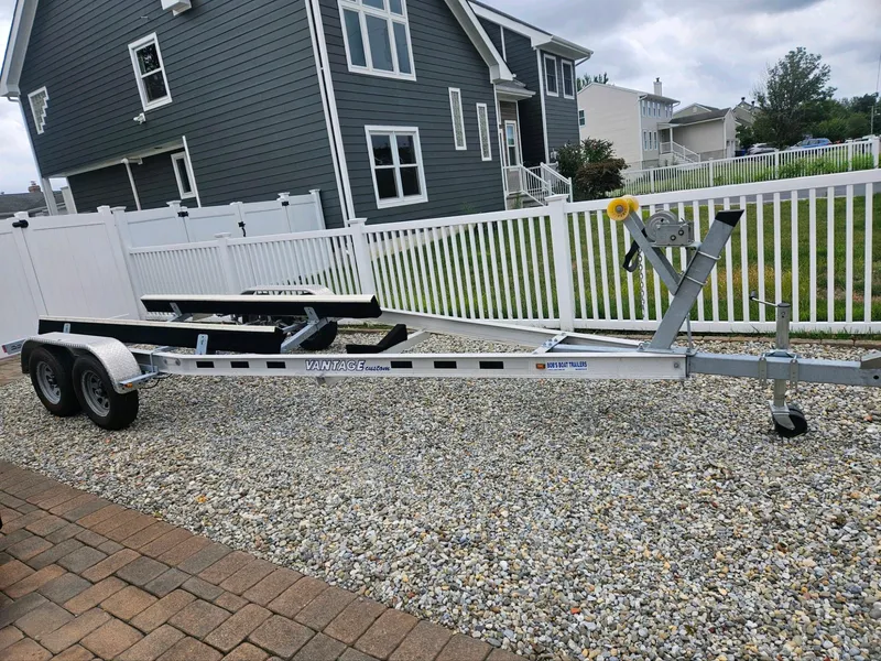 Slide: The Image of Trailer for Century 2301 Center Console 2020, parked on gravel near residential homes. - 35