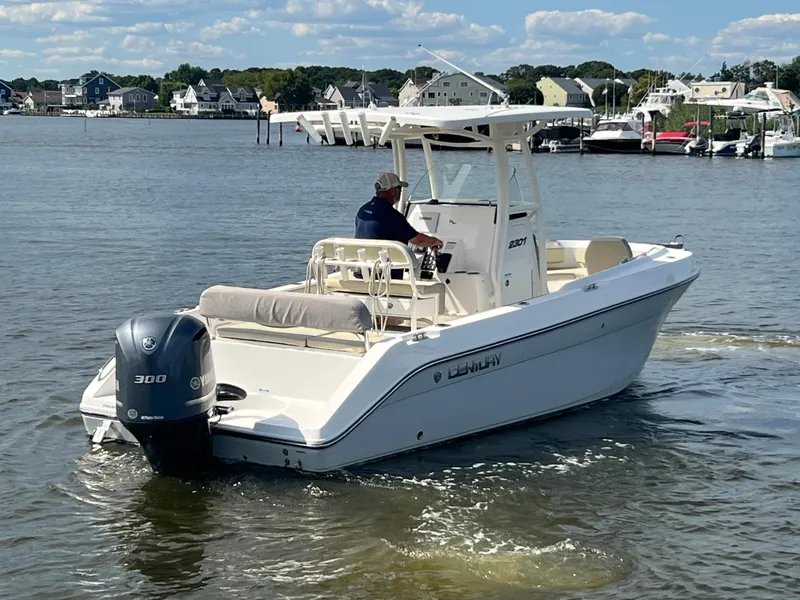 Slide: The Image of 2020 Century 2301 Center Console boat cruising on a calm river near a marina. - 4