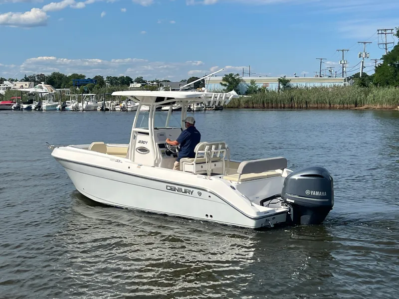 Slide: The Image of 2020 Century 2301 Center Console boat on calm water, featuring a Yamaha outboard motor. - 7